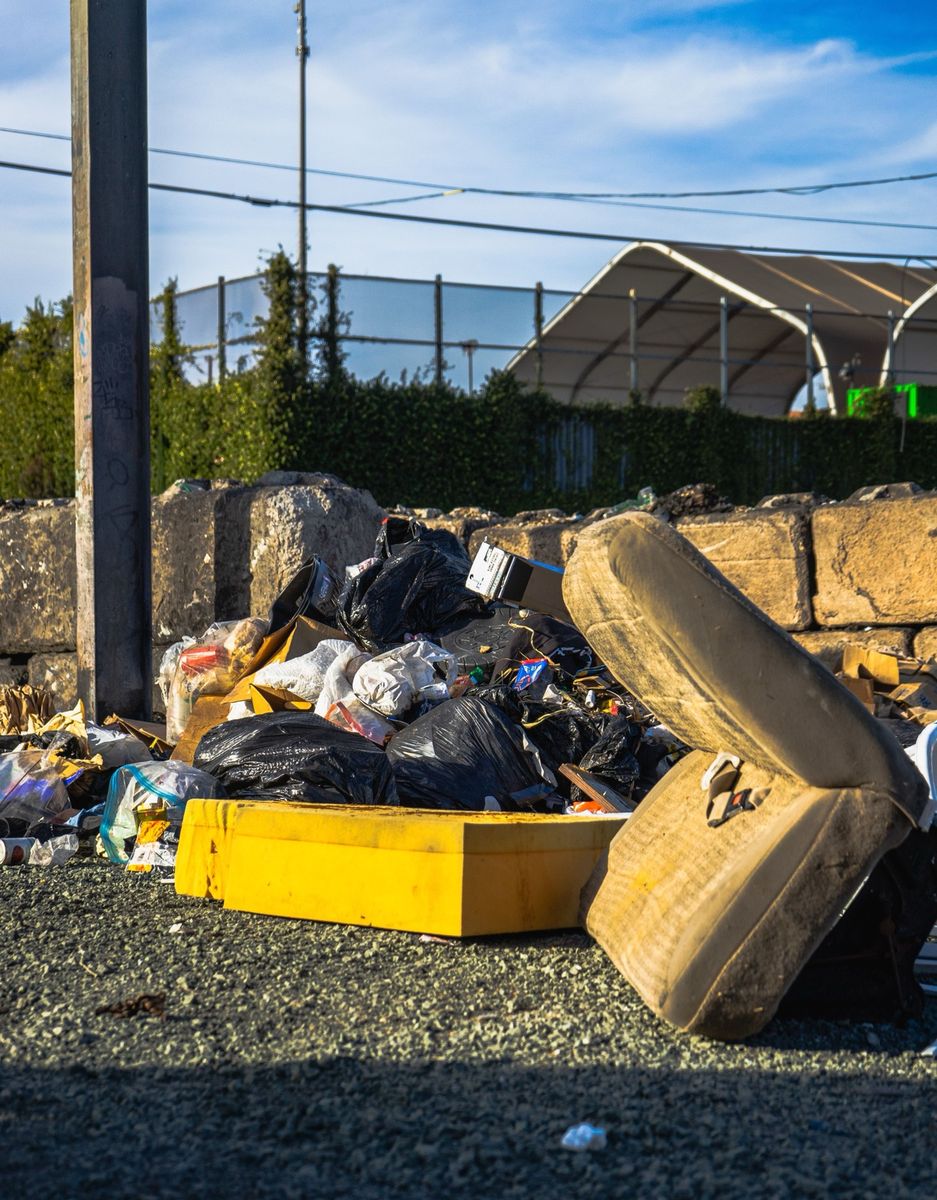Bulky mattress and household junk pile ready for removal